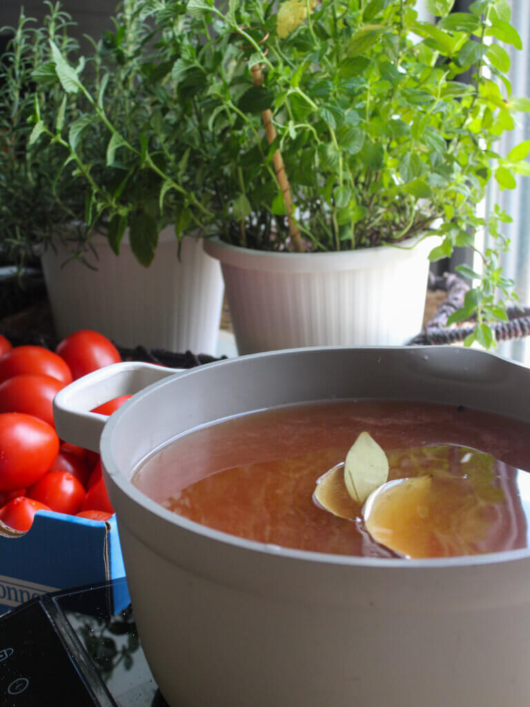 Warm homemade pickling brine with tomato paste, vinegar, salt, sugar, and spices prepared for classic Russian pickled tomatoes.